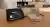 OMRON upper-arm blood pressure monitor with cuff sitting on a wooden table