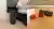 Side-by-side photographs of the EightSleep Pod hub next to a bed frame and a pair of orange-tinted Roka Wind-Down glasses resting on a wooden surface