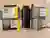 Four boxes of LMNT electrolyte drink mix stacked around a black insulated water bottle on a kitchen counter. Each box lists 1000 mg sodium, 200 mg potassium, and 60 mg magnesium per stick.
